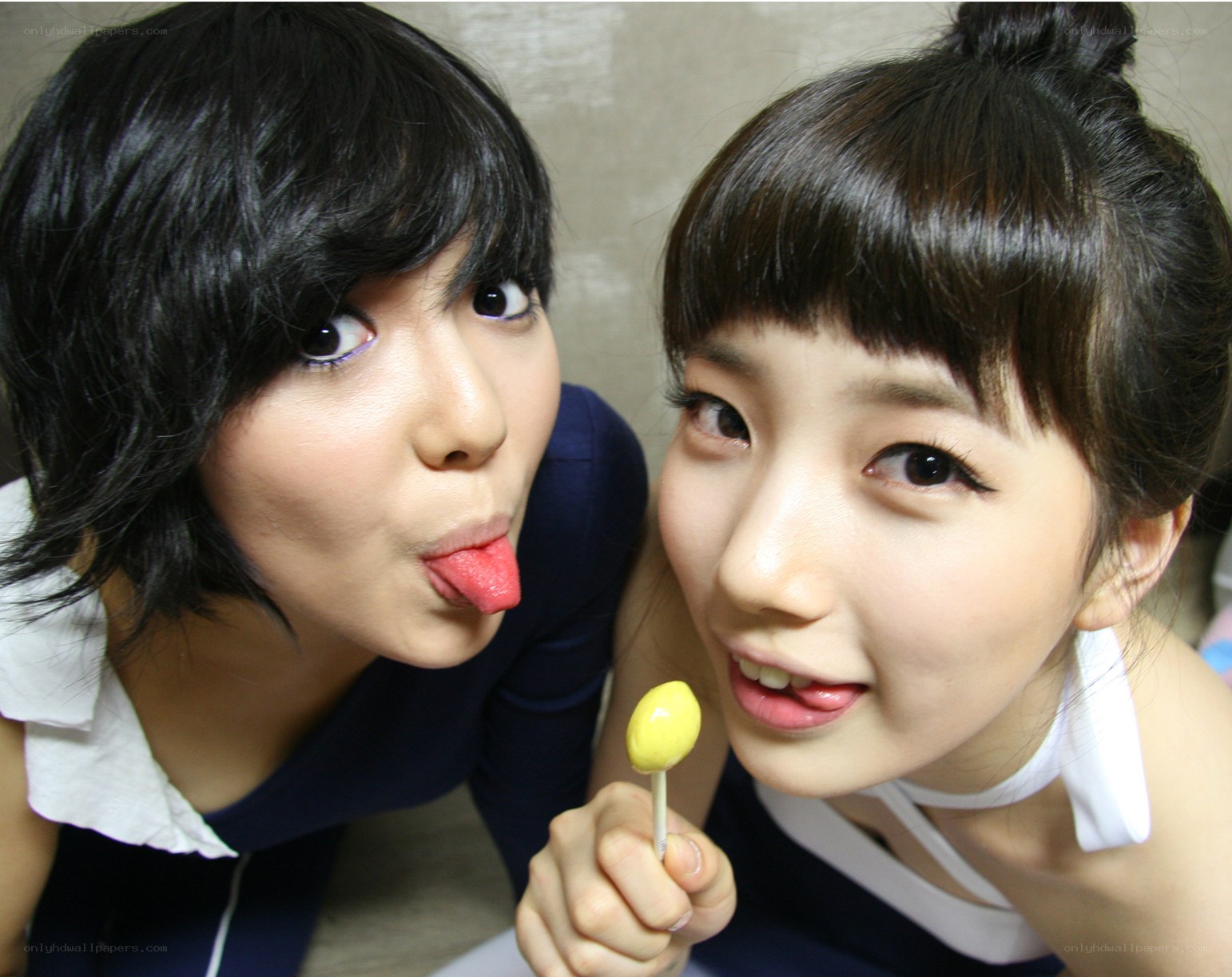 Two women with lollipops