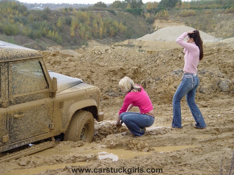 Two Women with Muddy Vehicle