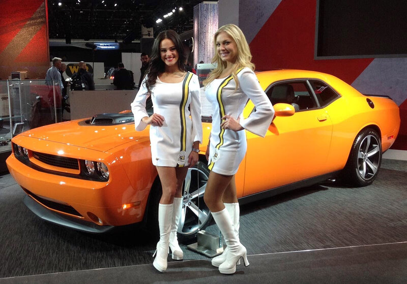 Two Women with Orange Car — Showroom