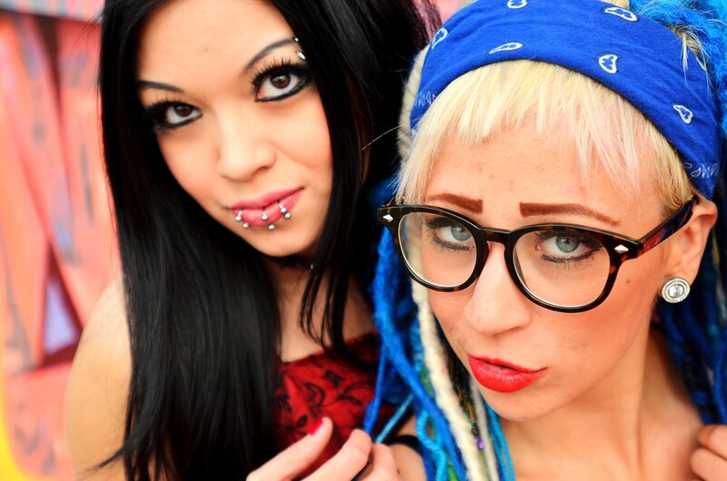 two women with piercings and glasses