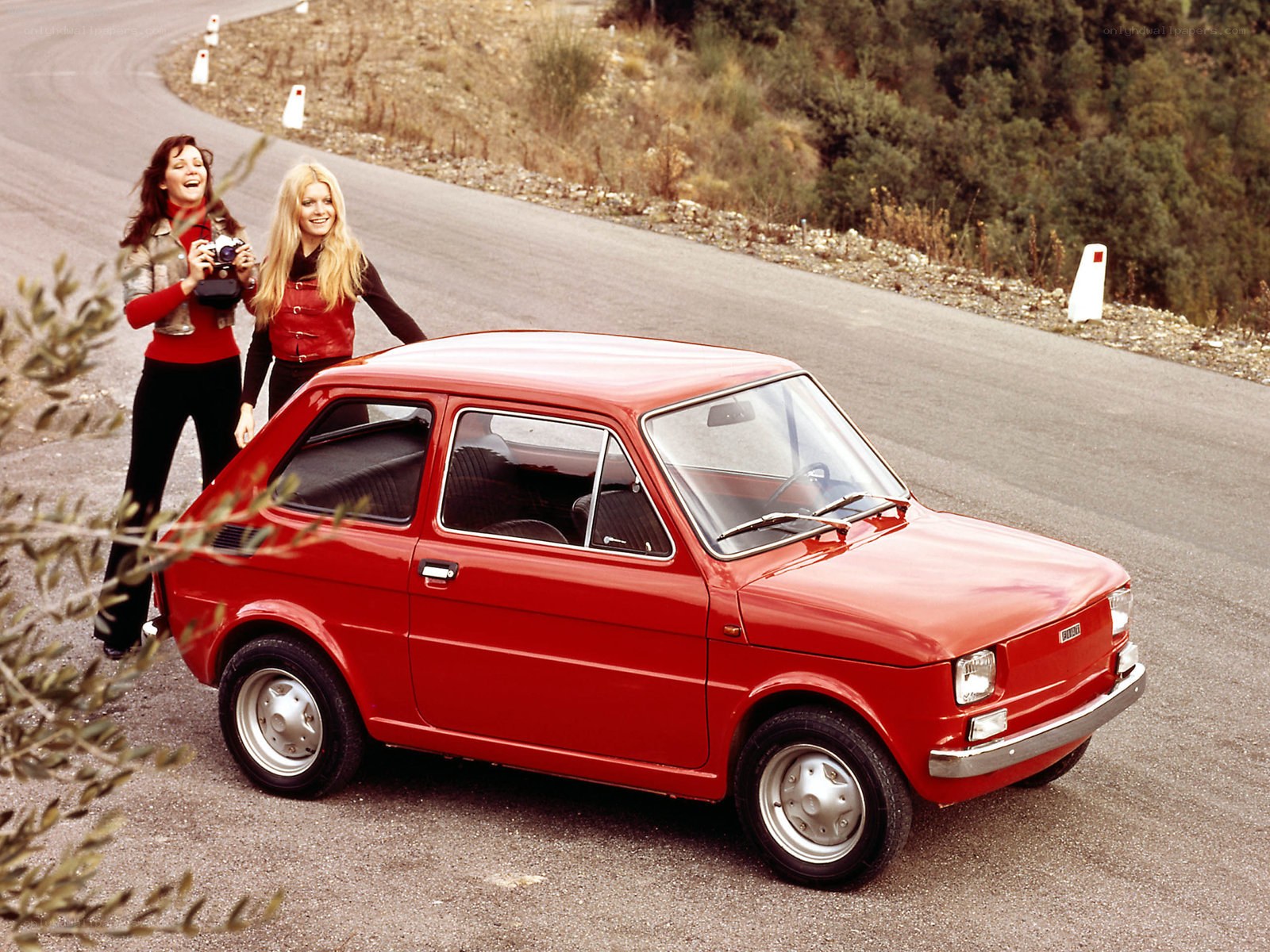 Two women with red car
