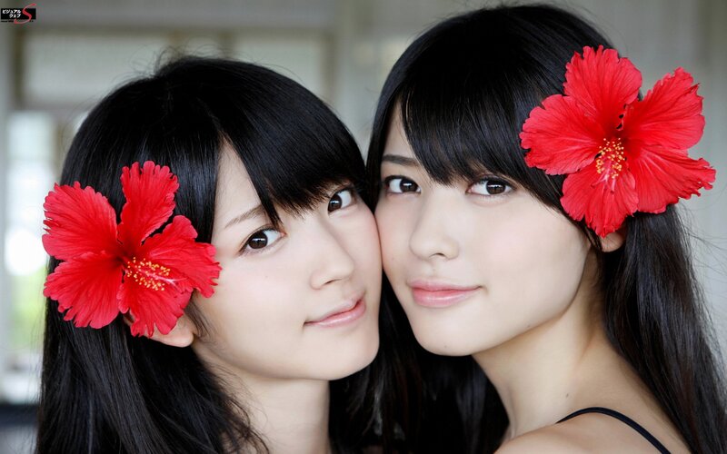 Two women with red flowers