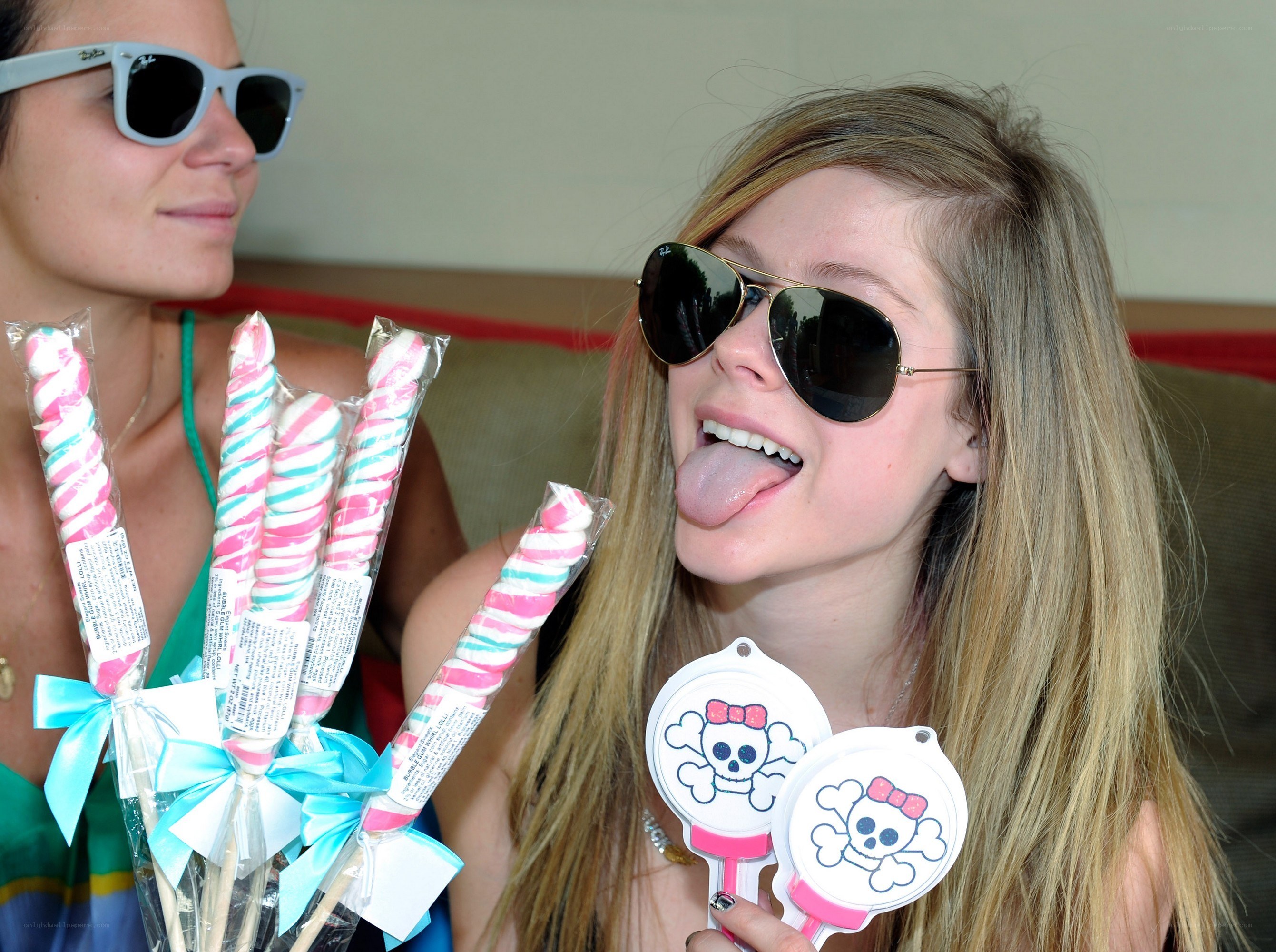Two women with sunglasses and candy