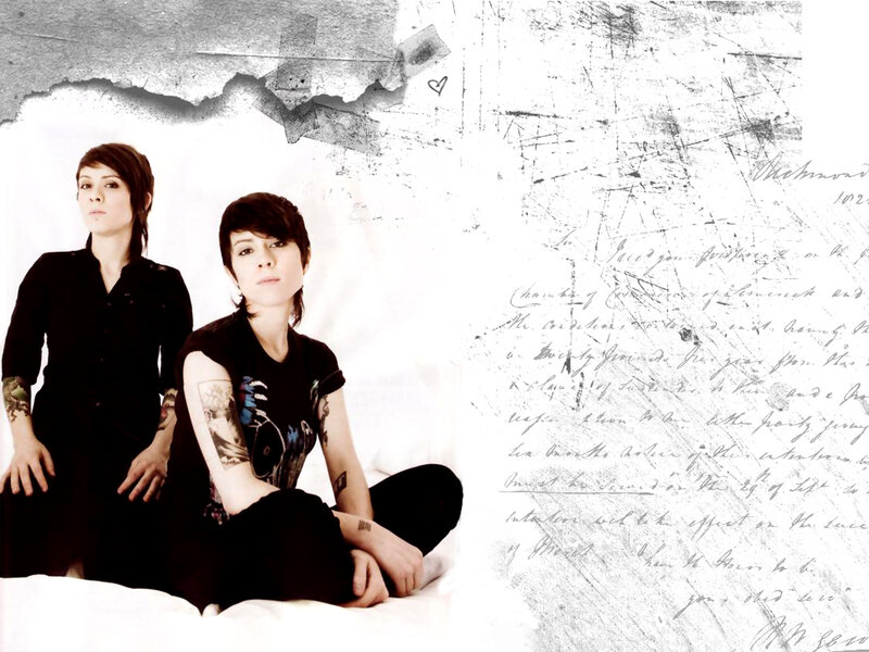 two women with tattoos on bed
