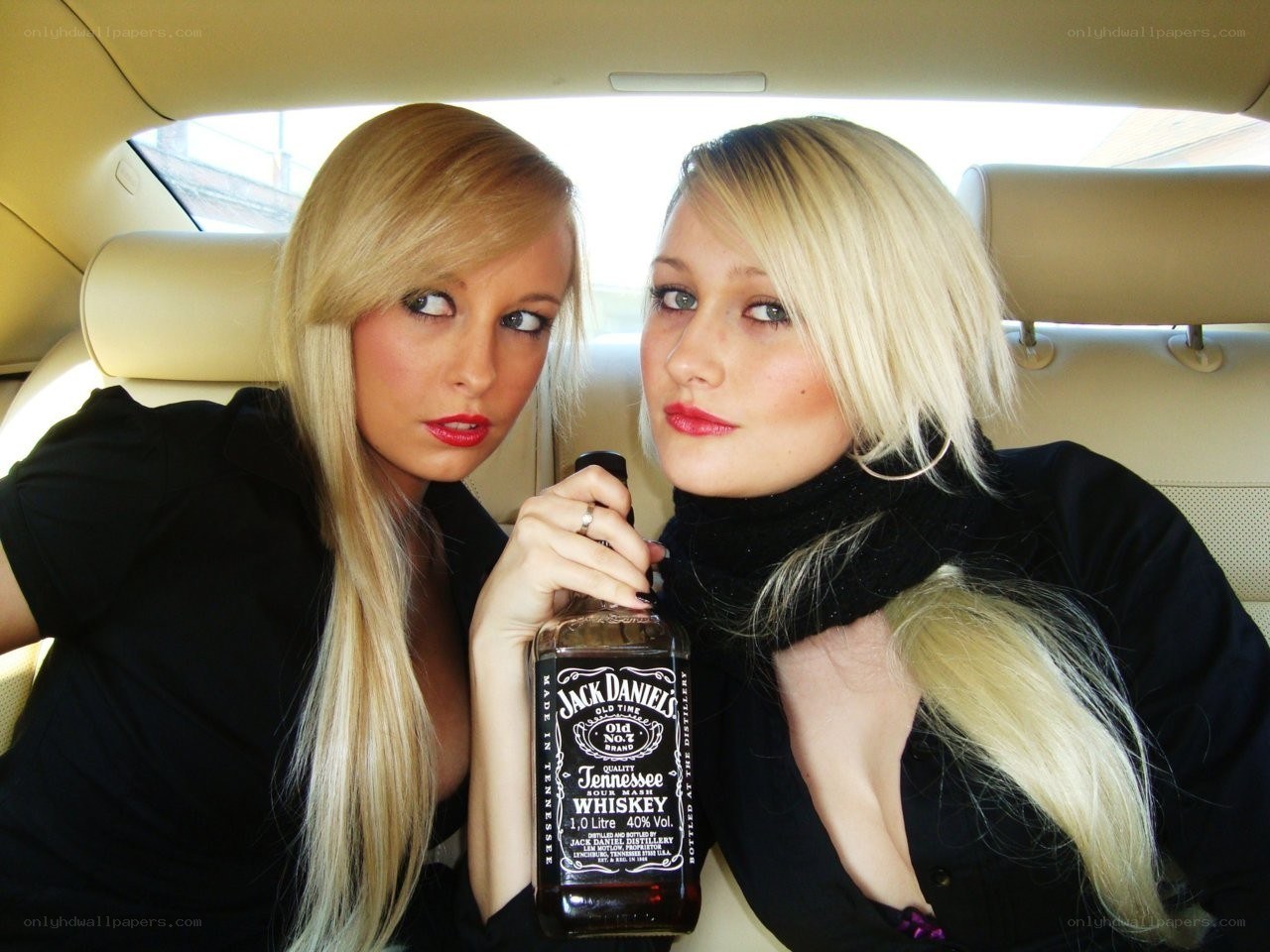 Two women with whiskey bottle