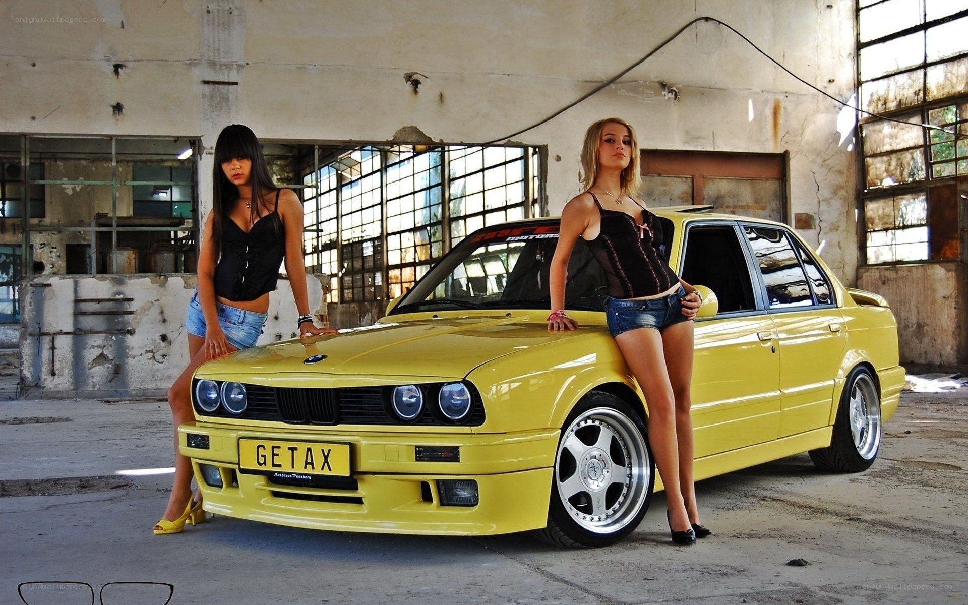 Two women with yellow car