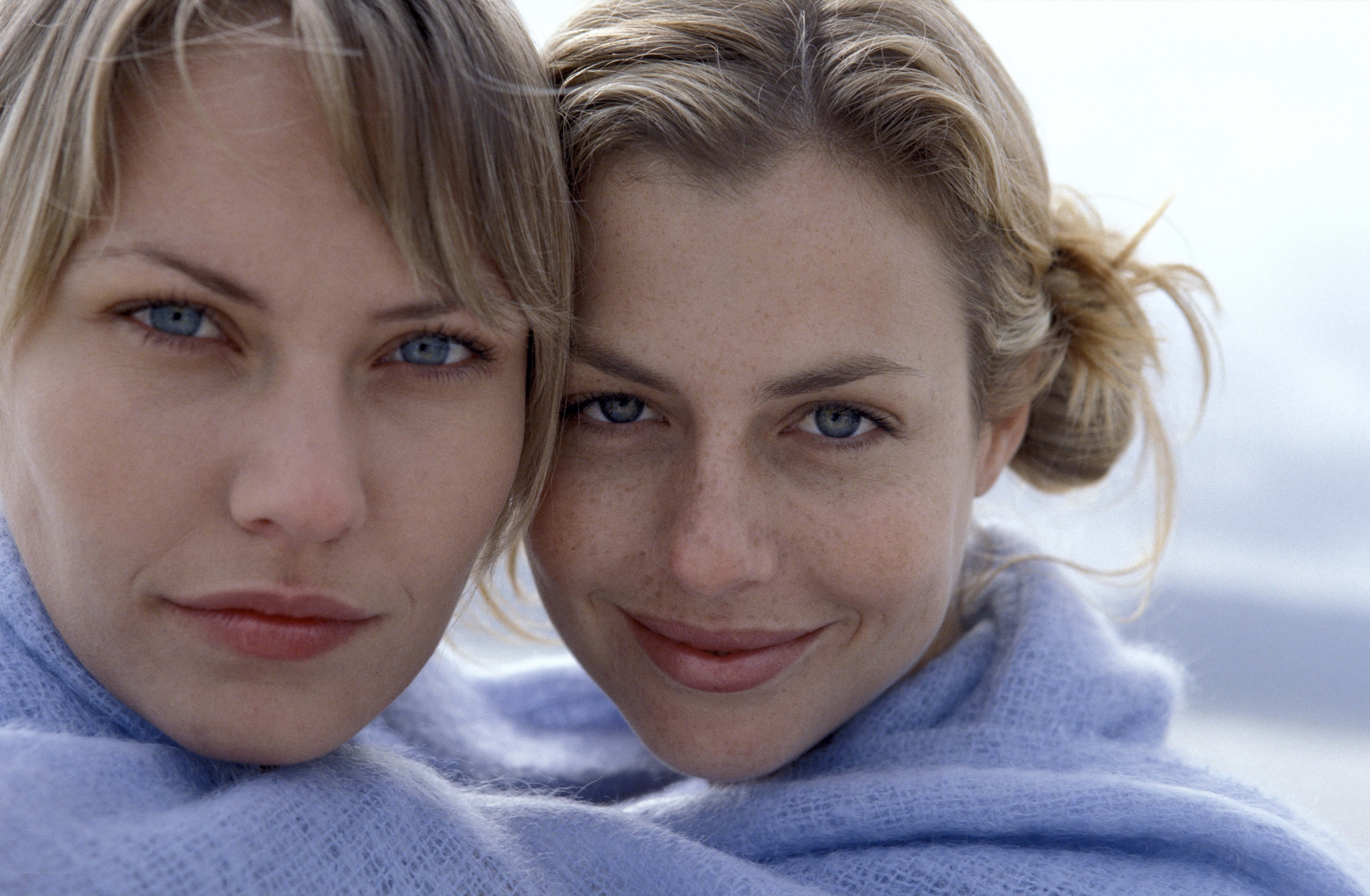 two women wrapped in a blanket