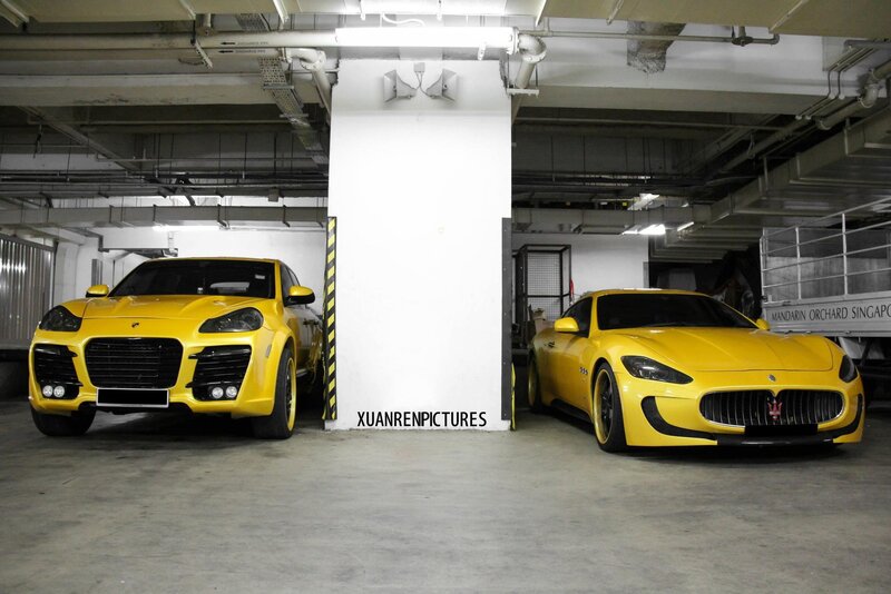 Two yellow luxury cars in garage