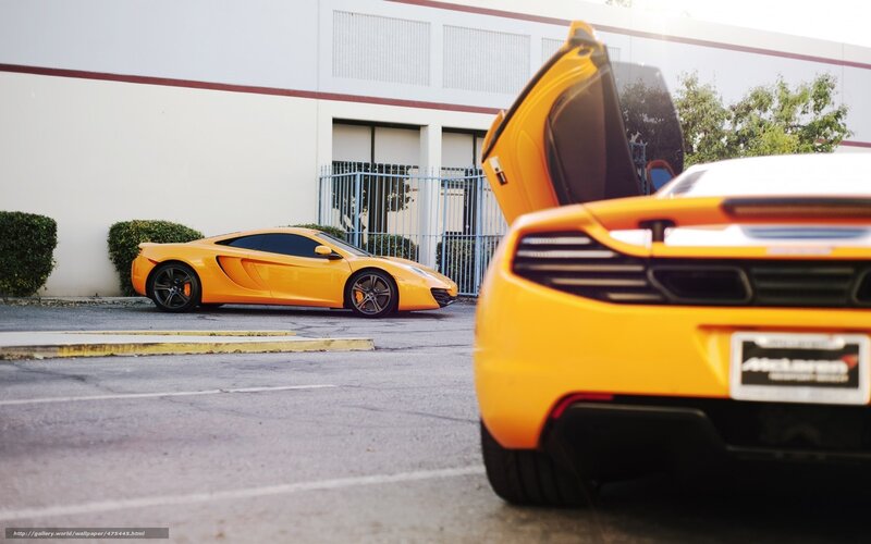 Two yellow McLaren sports cars
