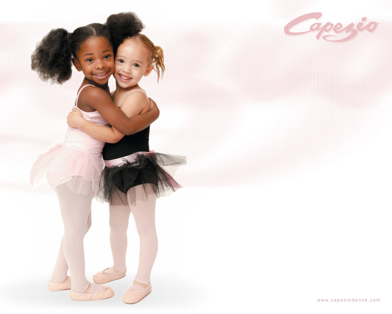 two young ballerinas hugging