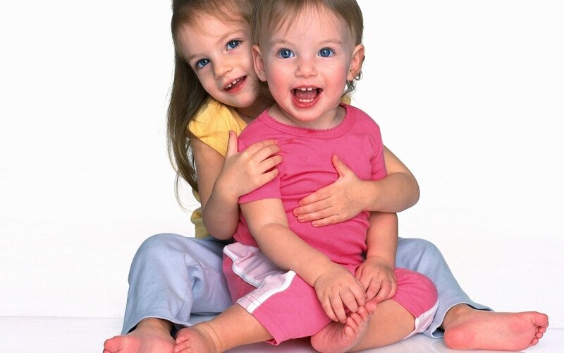 Two Young Children Hugging