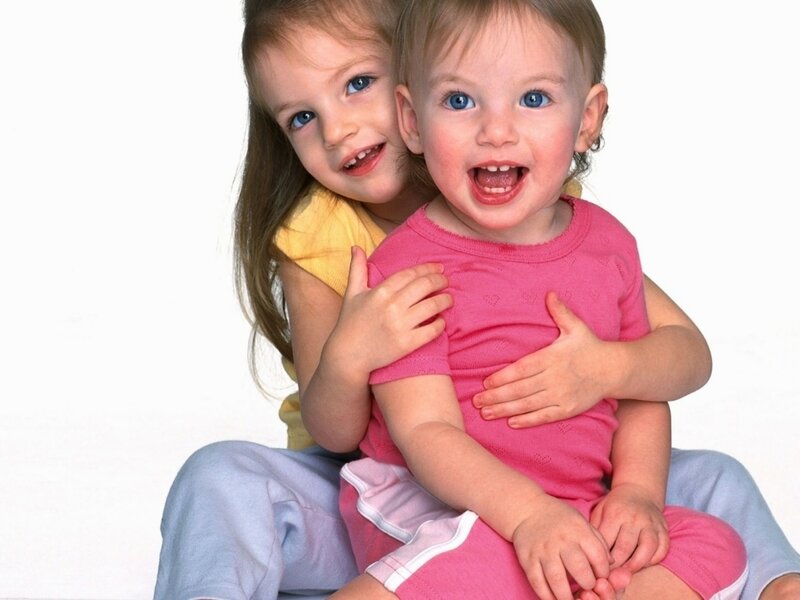 Two Young Girls Hugging — Pink