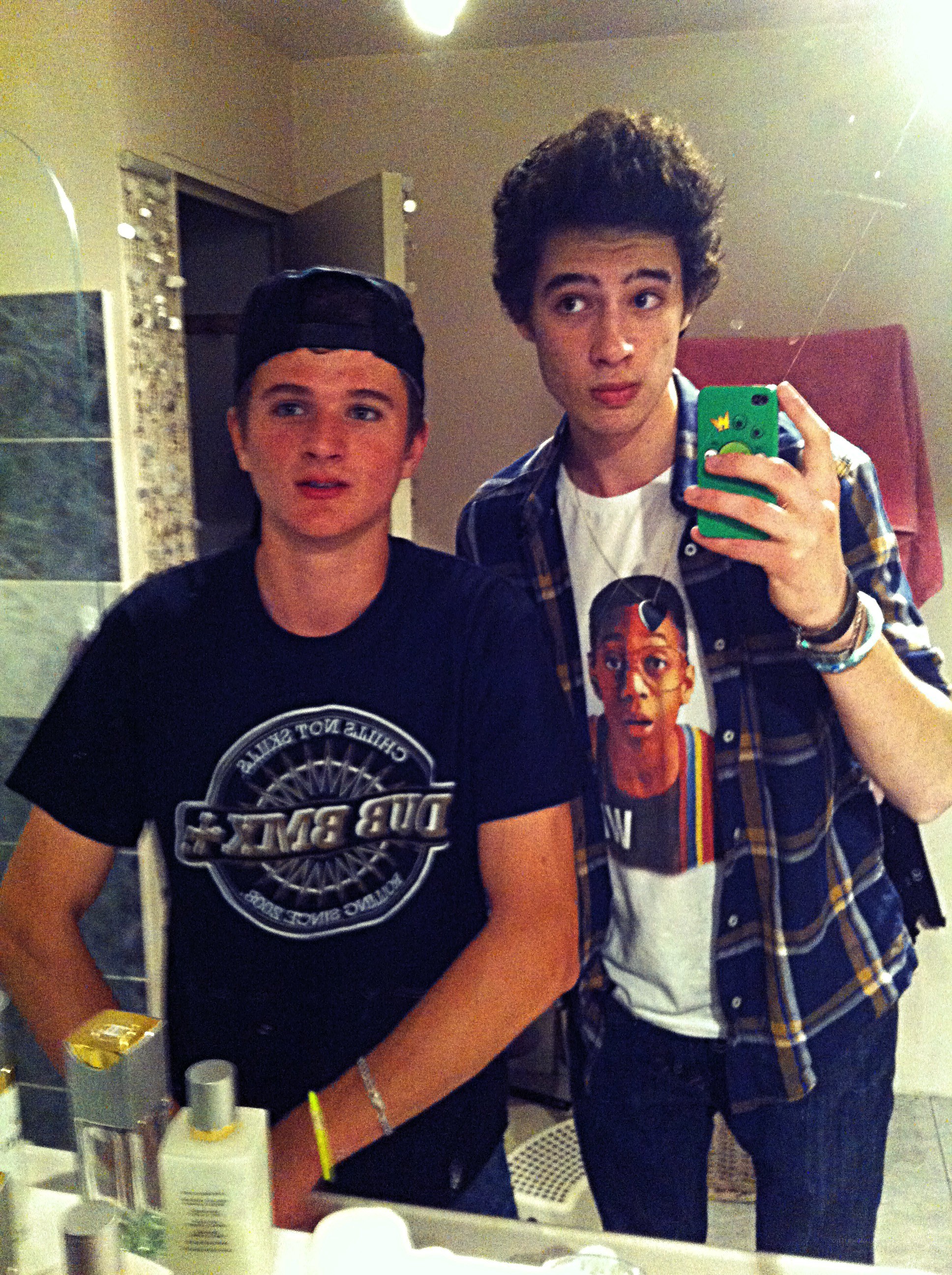 two young men in bathroom mirror