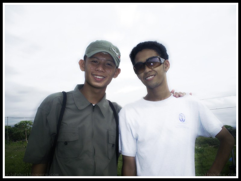 Two young men posing outdoors