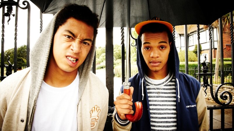 Two young men under an umbrella