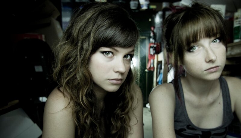 two young women in a cluttered room