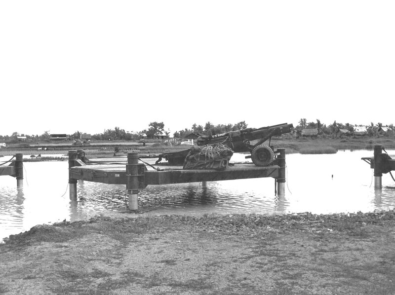 U.S. Army artillery on pontoon bridge
