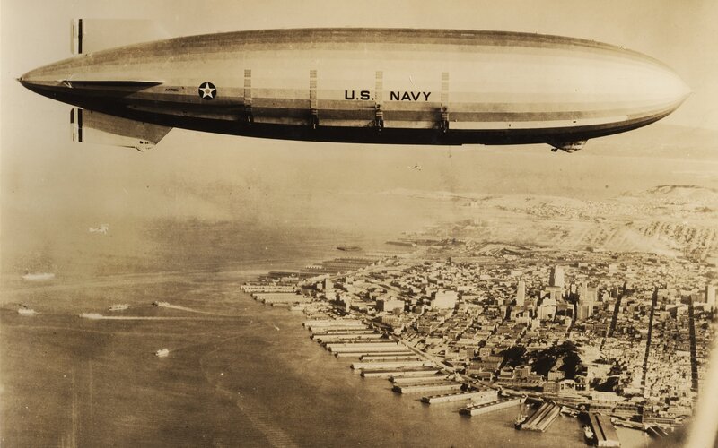 U.S. Navy blimp over city