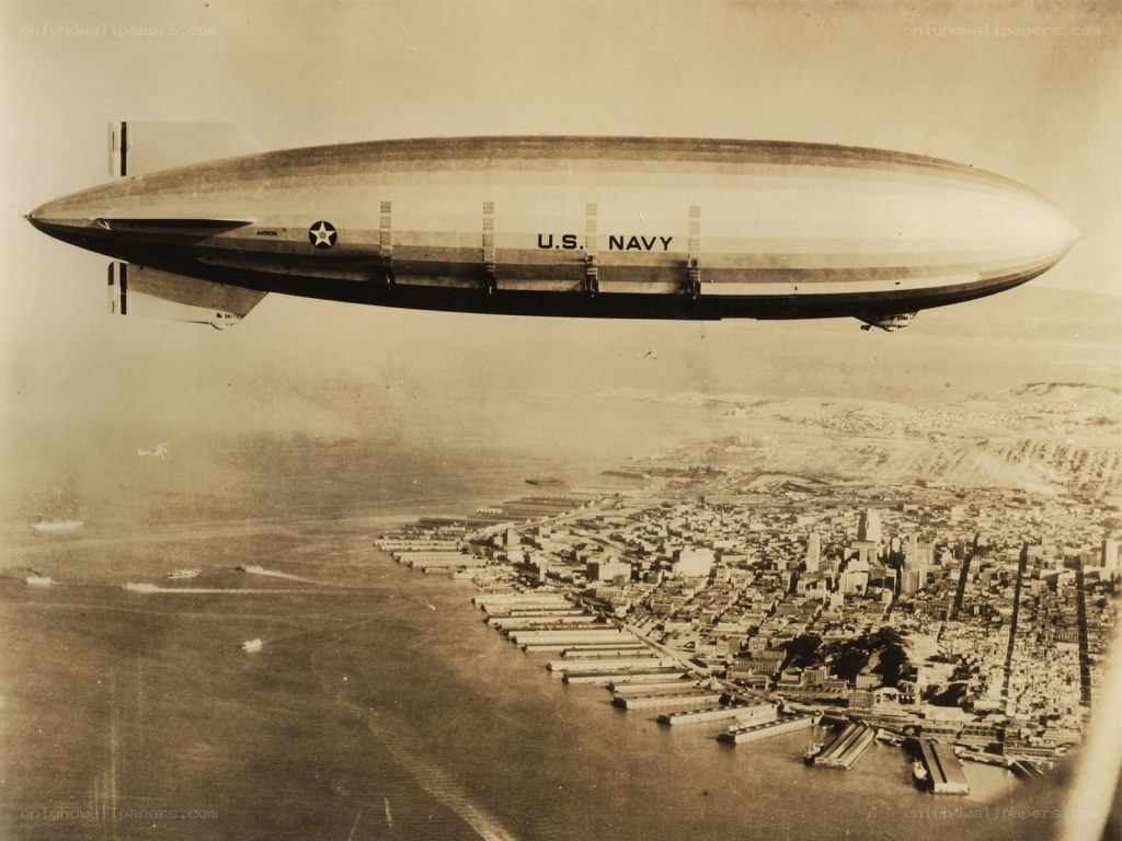 U.S. Navy blimp over city