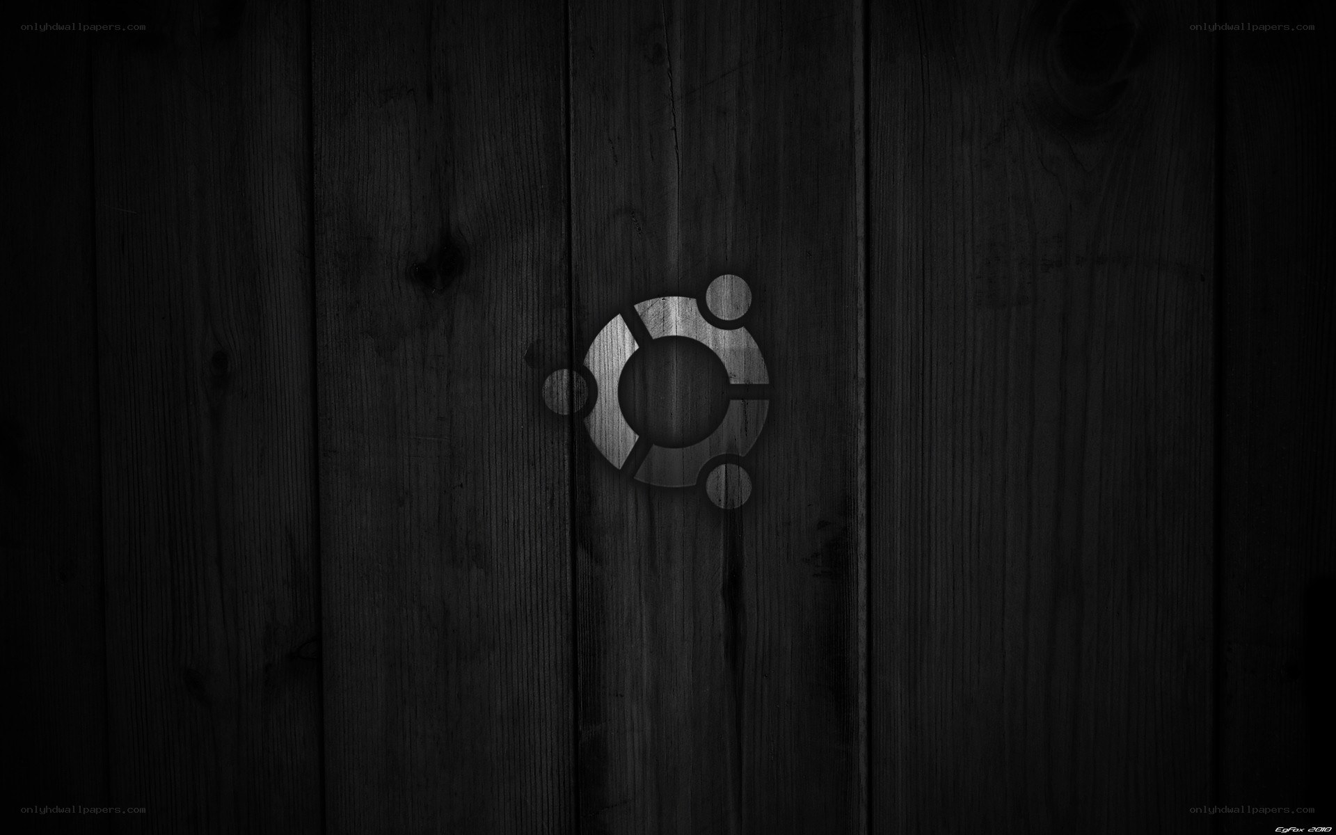 Ubuntu logo on dark wood