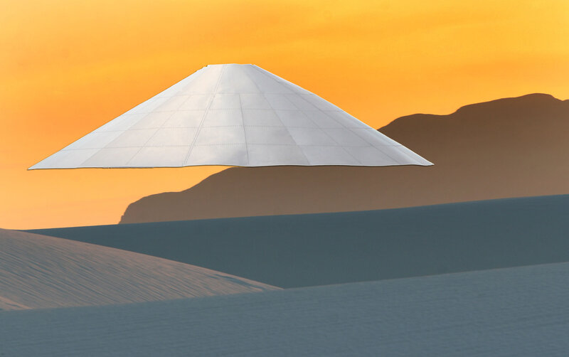 UFO over desert dunes