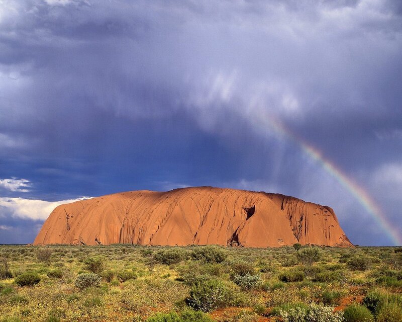 Uluru Rock Formation — Red, Dramatic, Afternoon, Photograph, Rainbow, Clouds, Desert Vegetation