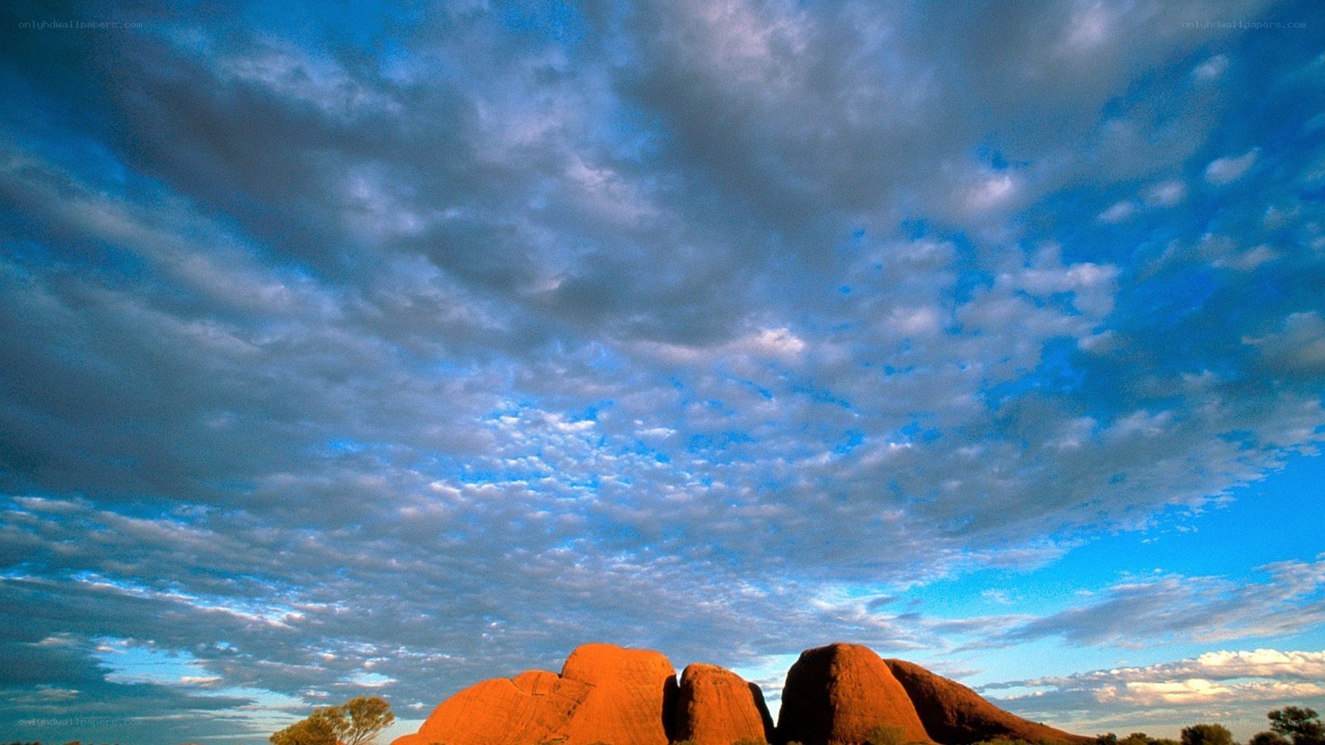 Uluru under a cloudy sky