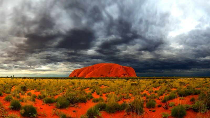 Uluru under stormy sky