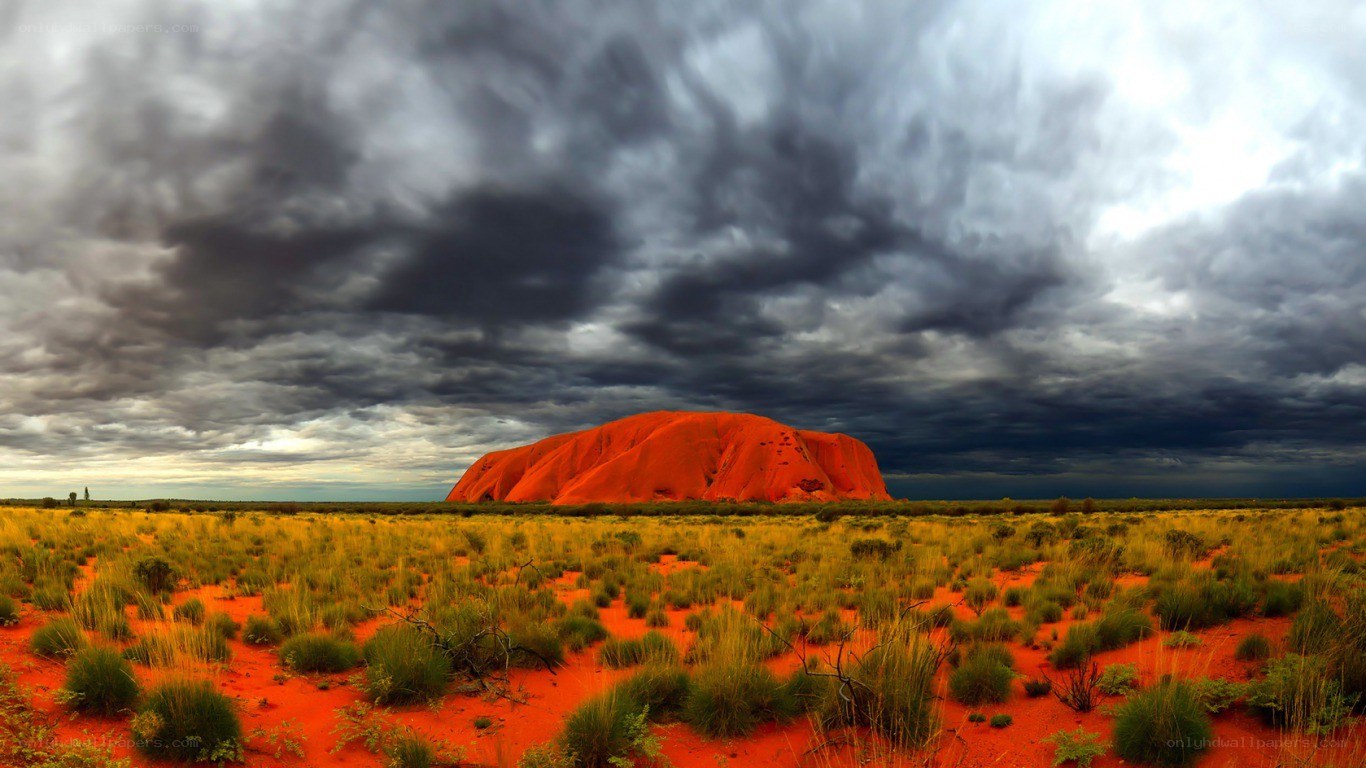 Uluru under stormy sky
