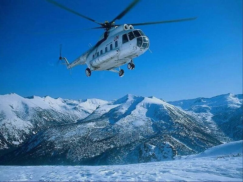UN helicopter over snowy mountains