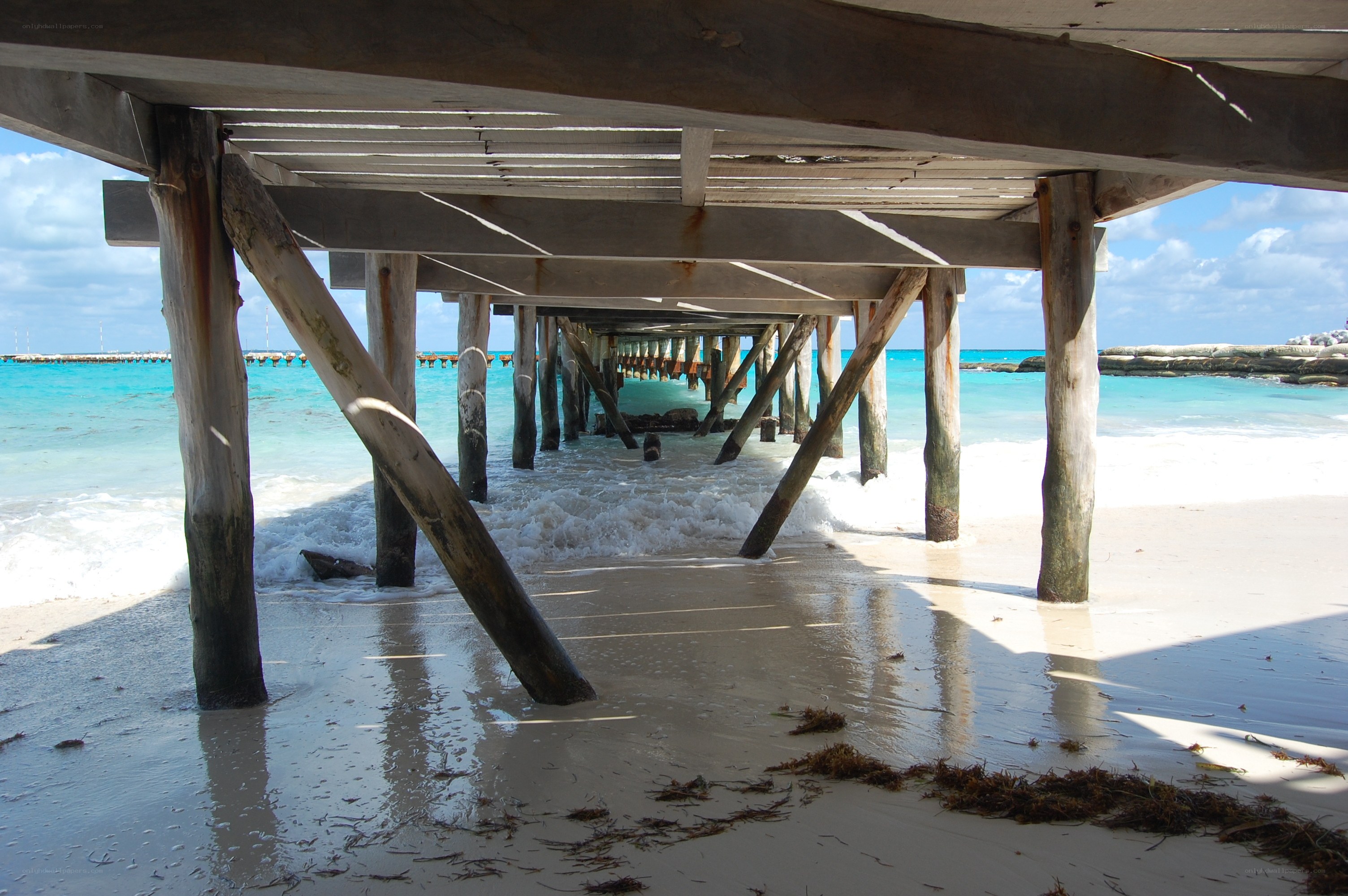 under the pier at the beach