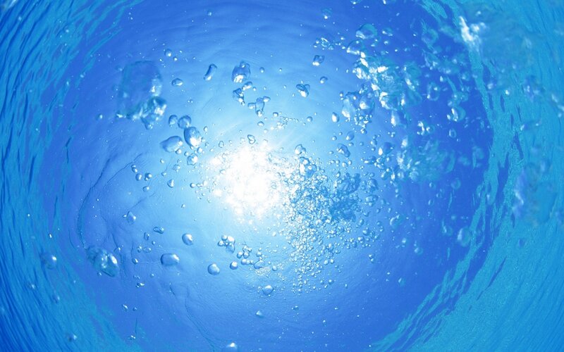 underwater bubbles rising to surface