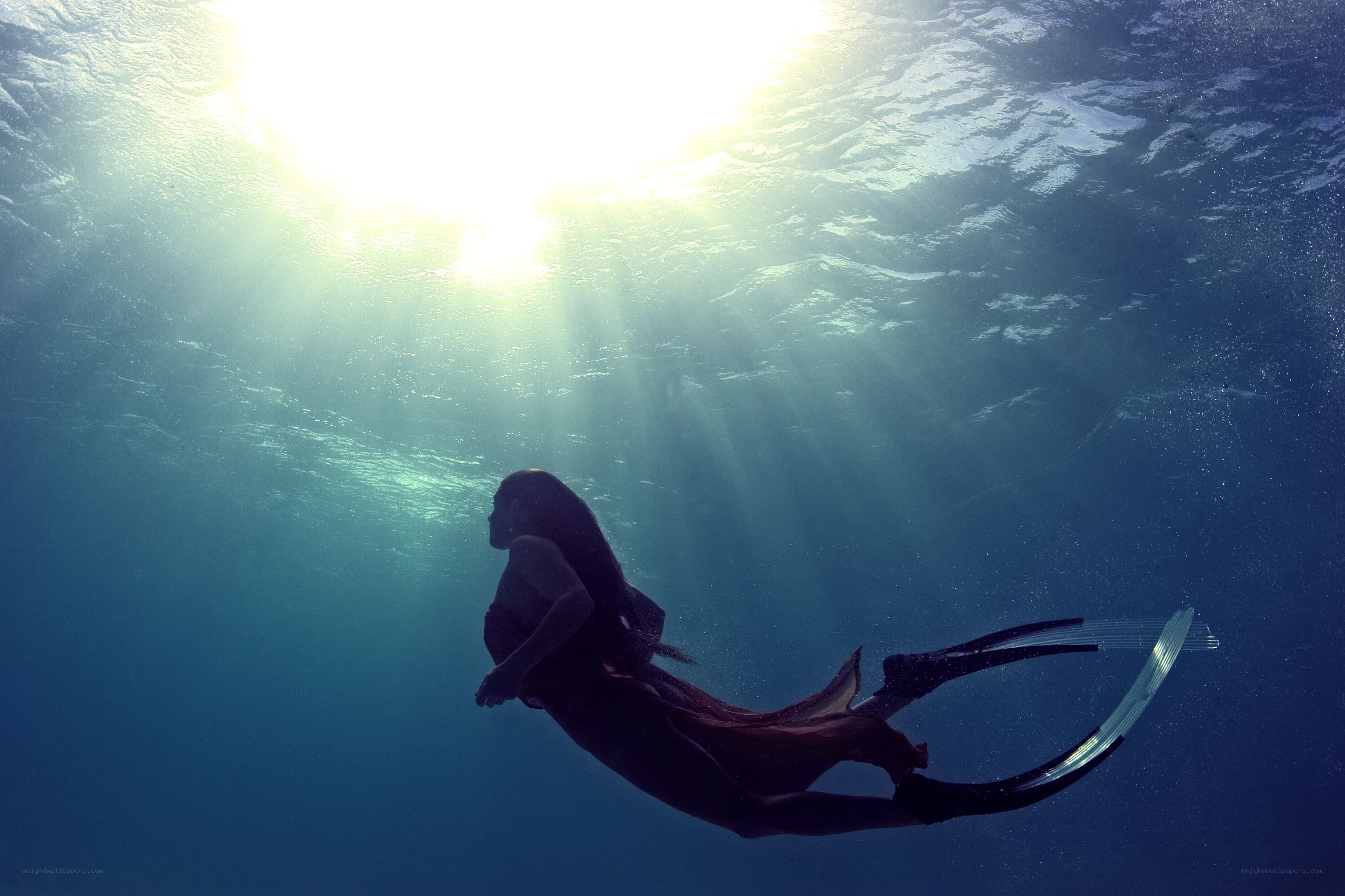 Underwater diver in sunlight