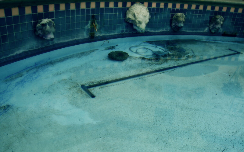 underwater pool with lion heads