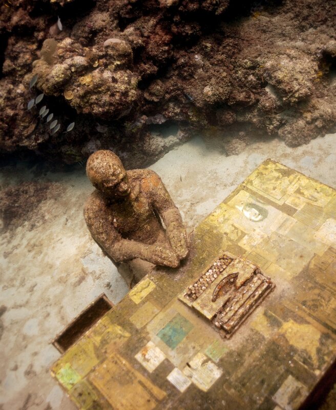 Underwater sculpture of a man at a desk