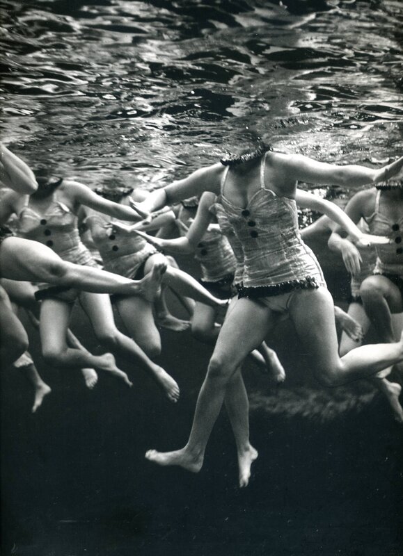 Underwater swimmers in vintage suits