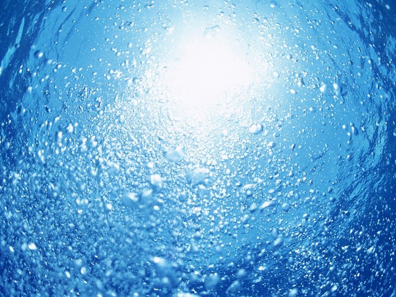 Underwater view of sunlit water