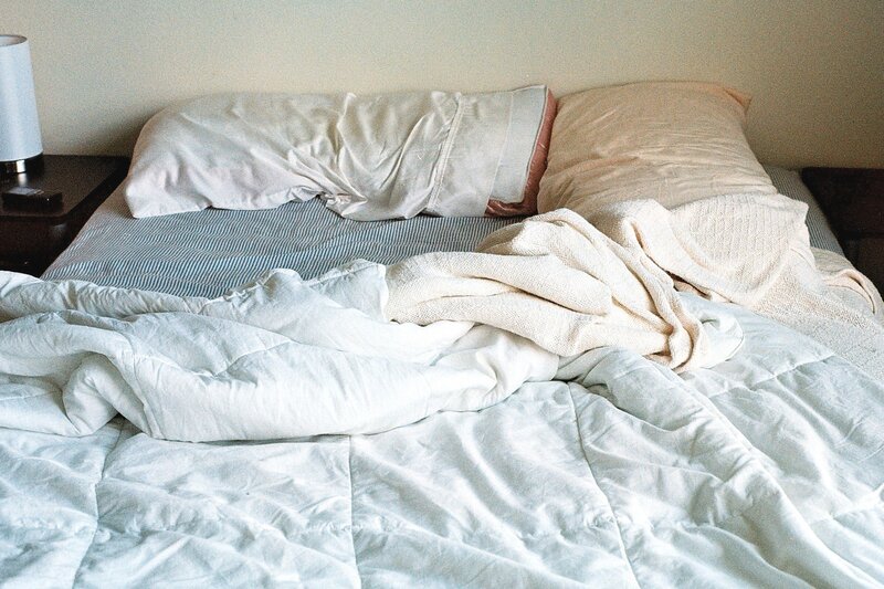 Unmade Bed with Pillows — White