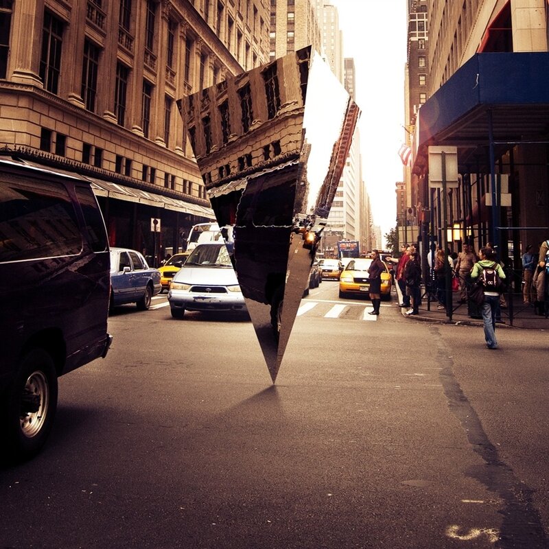 Urban street with reflective sculpture