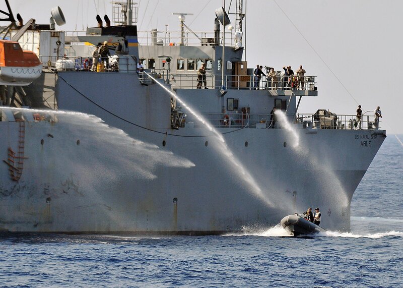 US Navy ship spraying water