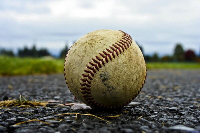 Used Baseball on Pavement