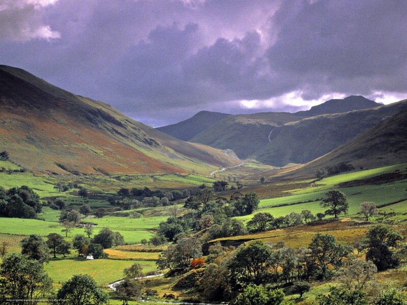 valley with green hills and purple sky
