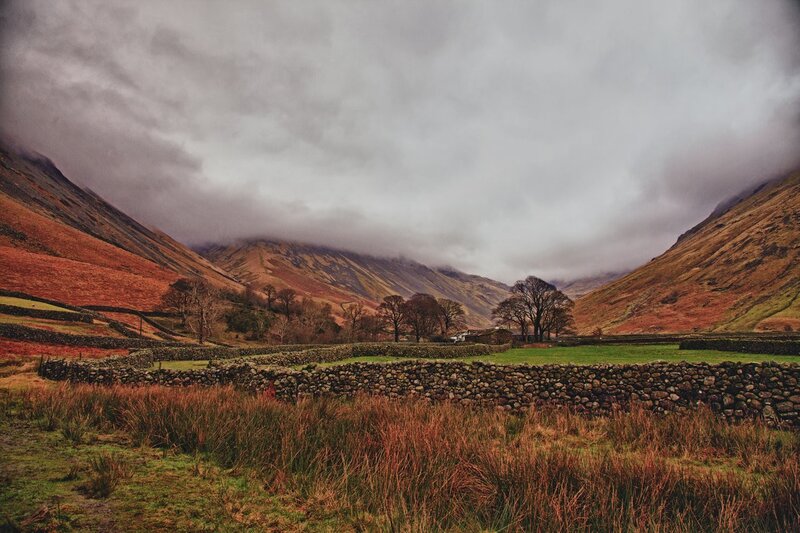 valley with stone walls and mist