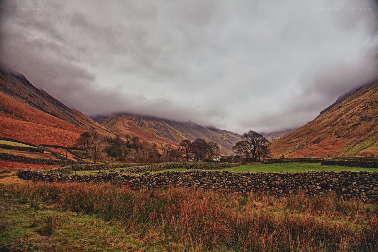 valley with stone walls and mist