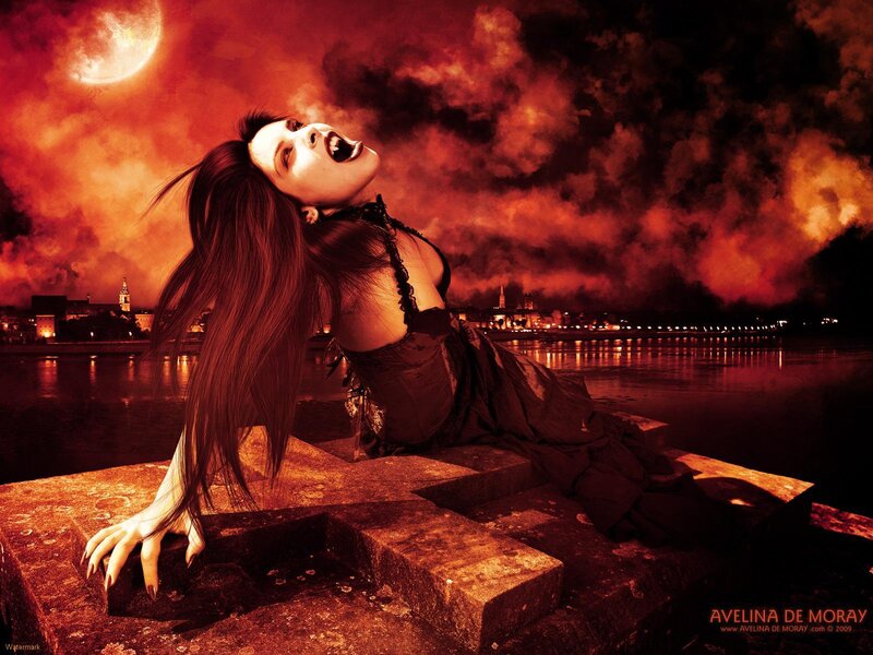 Vampire woman on a stone cross