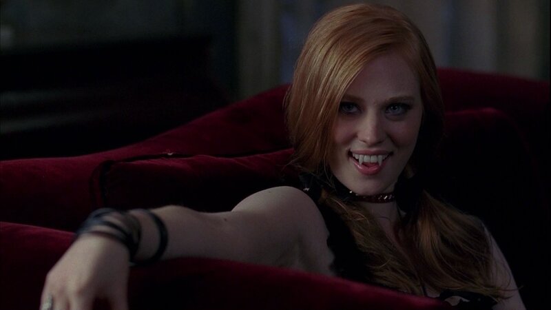 vampire woman on red couch