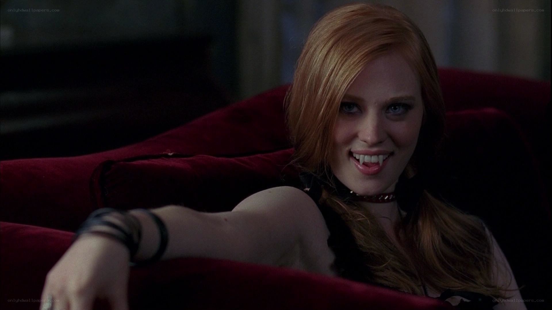 vampire woman on red couch