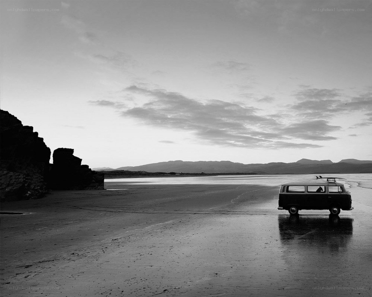Van on a wet beach at dusk