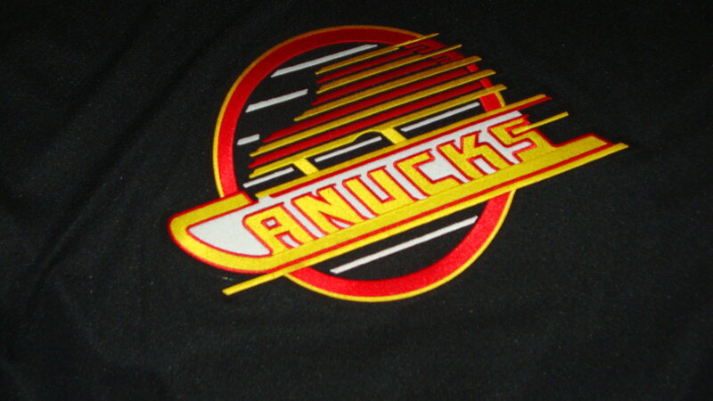 Vancouver Canucks logo on black fabric