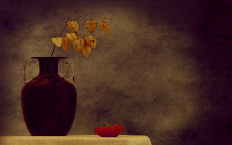 Vase with dried flowers and pepper